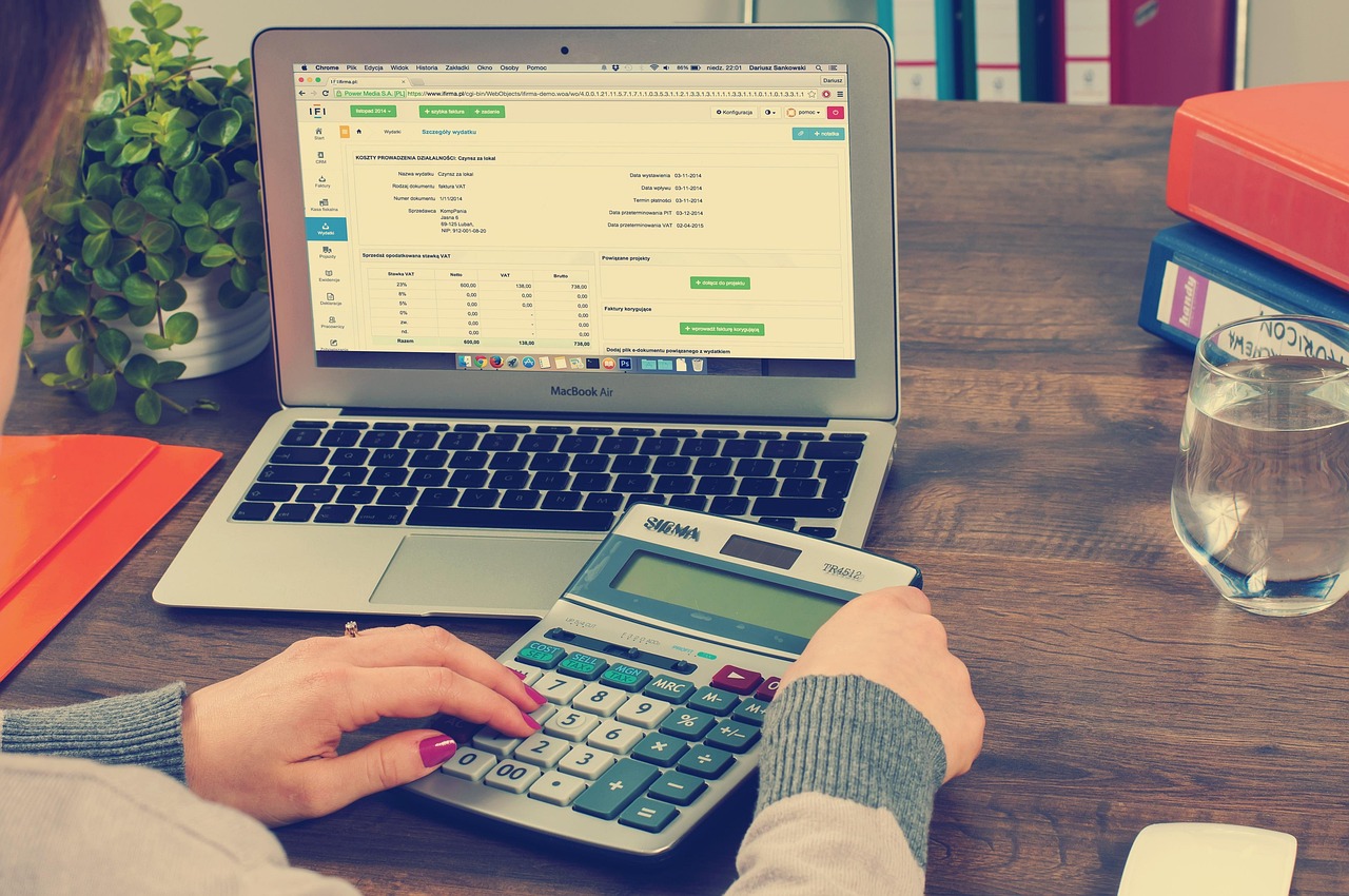 une personne avec une calculatrice qui calcule le coût de sa maison et de sa valeur locative